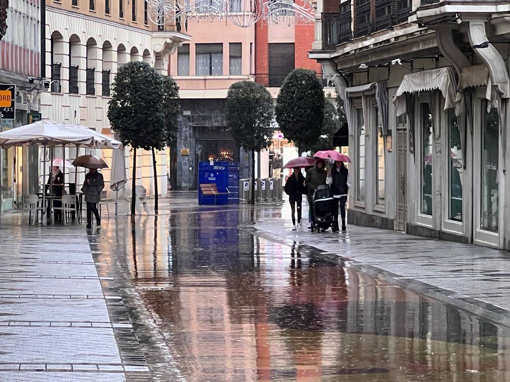 Una persona salta una balsa de agua en una calle de Valladolid.