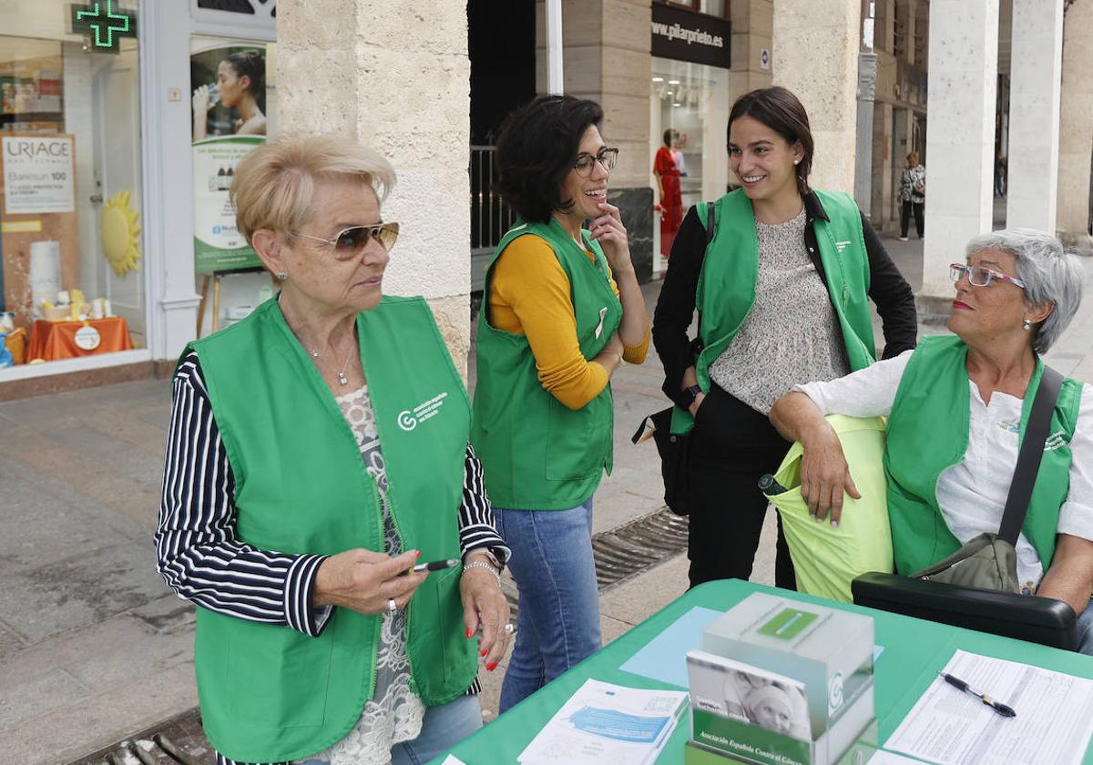 La psicóloga Valeria Sánchez-Nebreda, de pie a la derecha, con voluntarias de la Asociación Contra el Cáncer, recogen firmas.