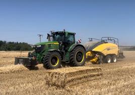 Un agricultor empaca paja.