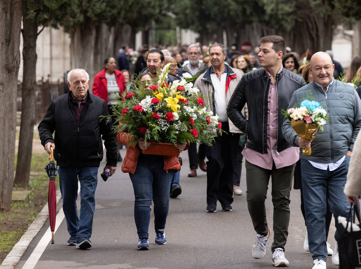 Familias vallisoletanas llevan flores en su visita al cementerio.