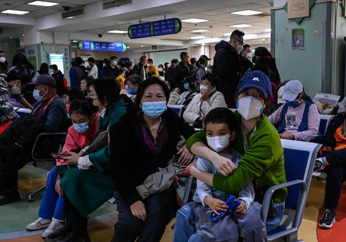 Niños enfermos esperan con sus familias en la sala de espera de un colapsado hospital de Pekín.