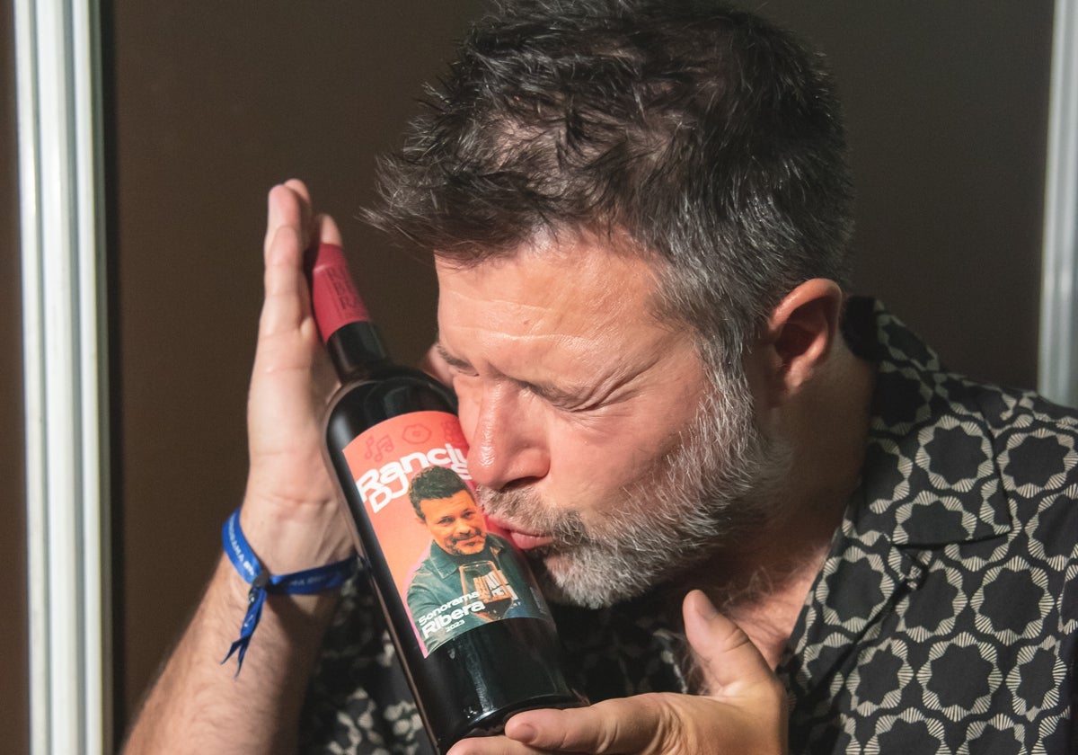 Héctor de Miguel besa una botella etiquetada con su imagen.