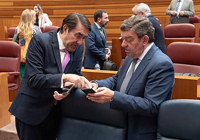 El consejero Luis Miguel González Gago conversa en las Cortes con su compañero de Medio Ambiente, Vivienda y Ordenación del Territorio.