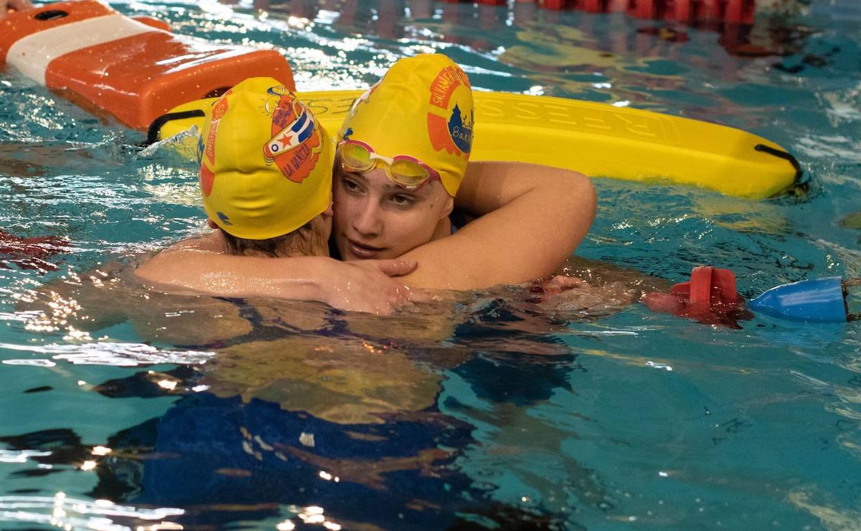 Dos deportistas se abrazan al concluir una de las pruebas. 