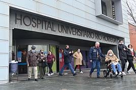 Pacientes y acompañantes portan mascarillas a la salida del Hospital Río Hortega