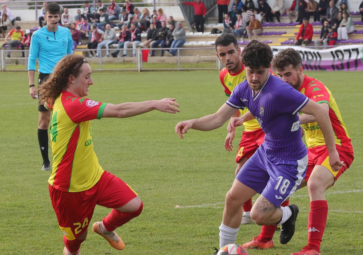 Toquero conduce el balón ante varios rivales del Tordesillas, este domingo en el Mariano Haro.