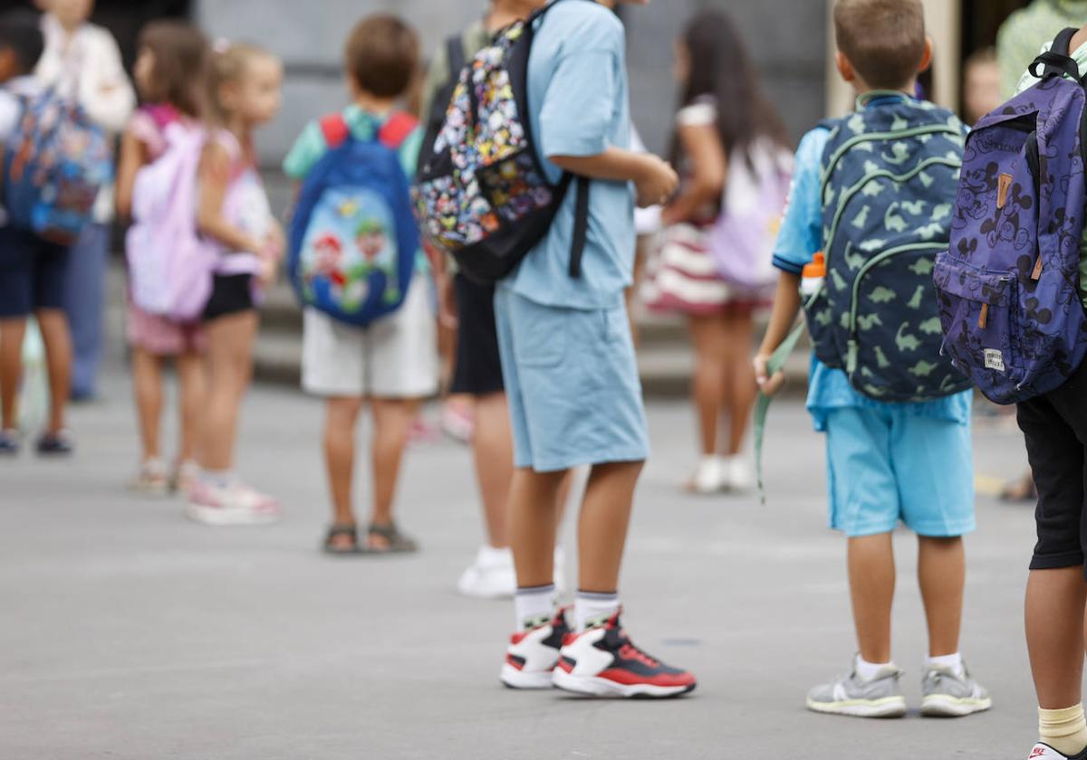 Un grupo de niños a las puertas del colegio.