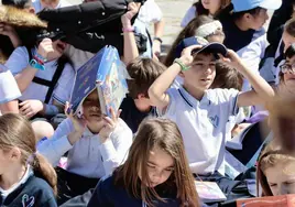 Varios niños leen en la plaza de San Pablo en la novena quedada literaria del colegio Amor de Dios.