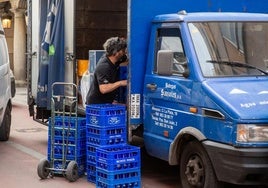 Un repartidor suministra agua mineral a establecimientos hosteleros del centro de Valladolid.