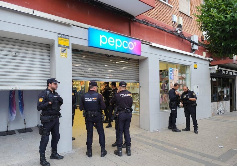 Varios agentes de la Policía Nacional, en la puerta de la tienda durante la intervención.