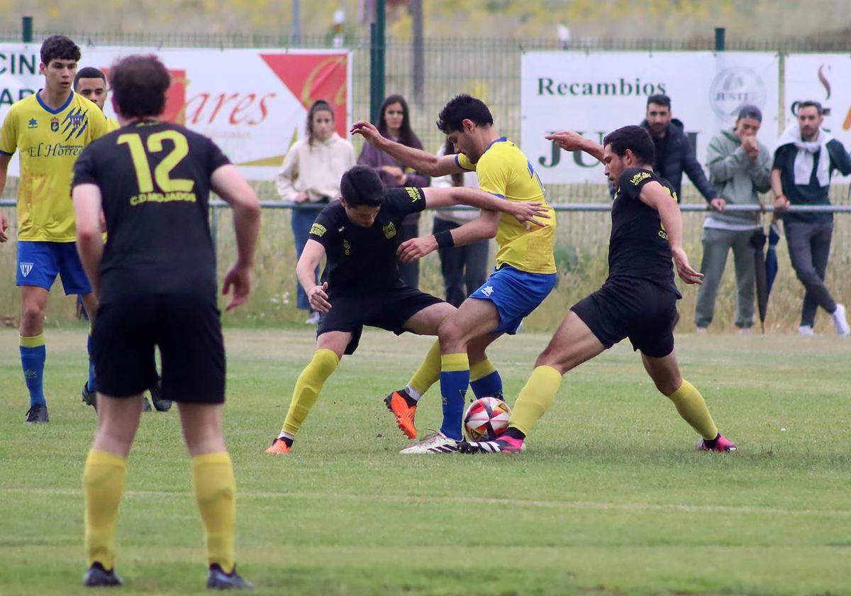 Dos jugadores del Mojados tratan de arrebatar el balón a un rival durante el partido en tierras leonesas.