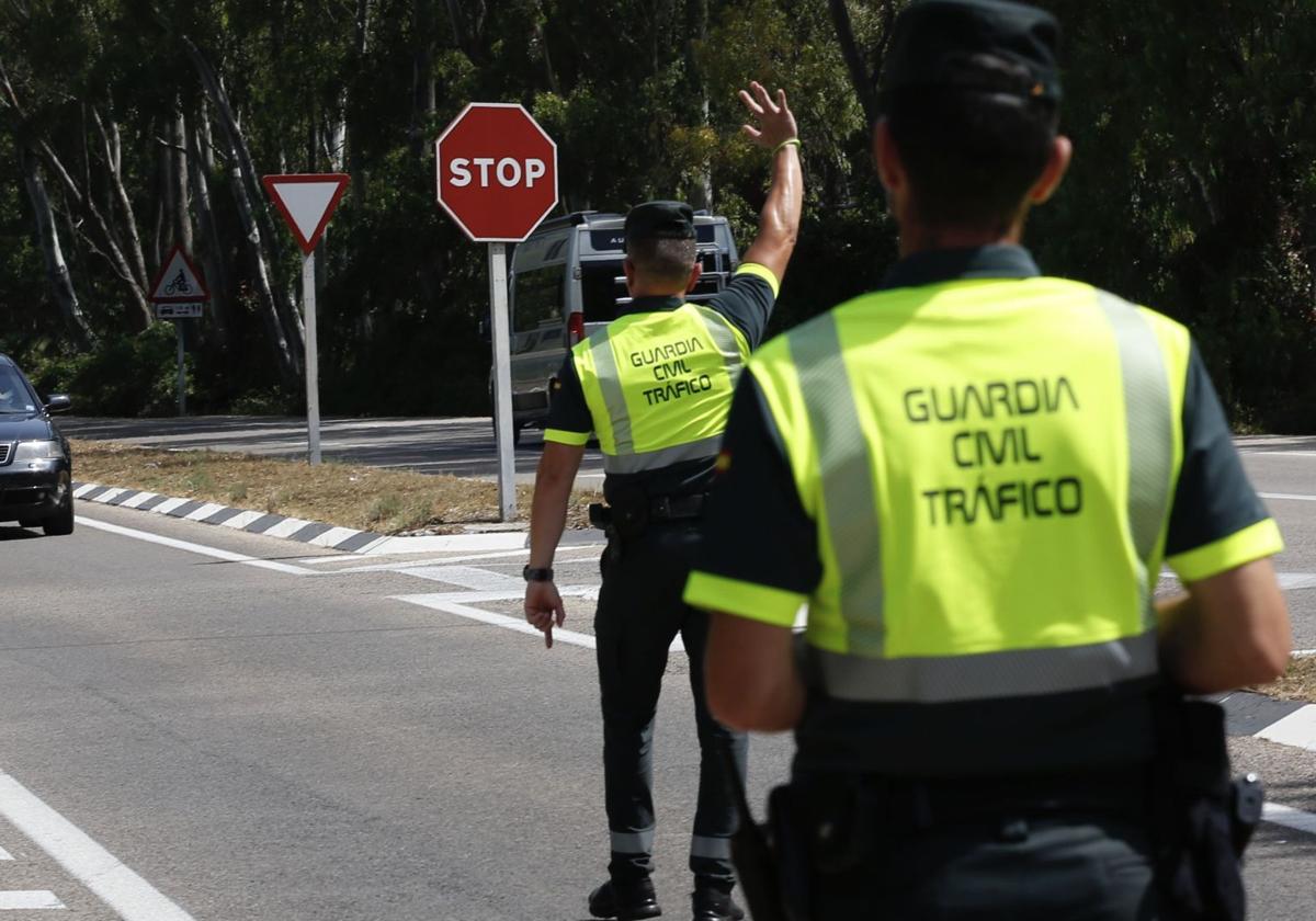 Agente de la Guardia Civil de Tráfico da el alto a un vehículo, en imagen de archivo.