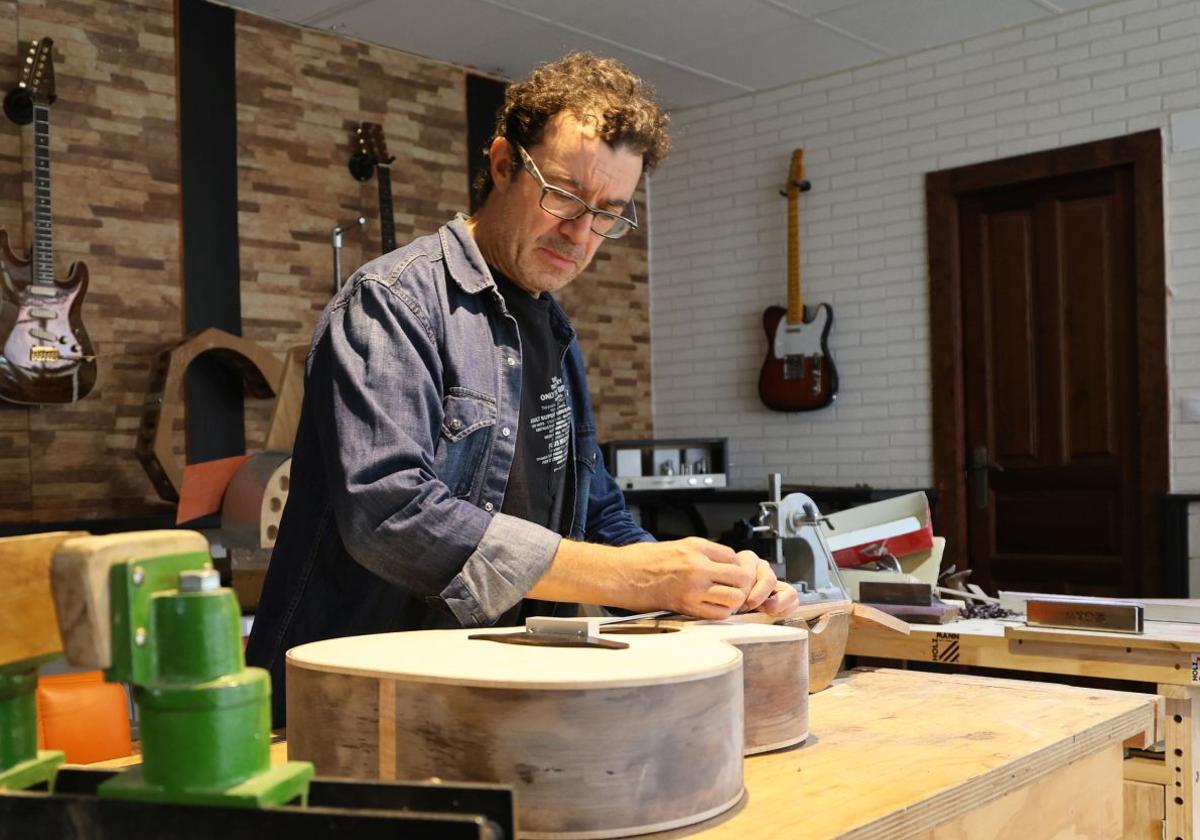 Rafael Fuentes trabaja en una de sus guitarras en el taller de Parquesol.