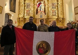 El matrimonio en su visita a la ermita con una bandera peruana con la imagen del santo