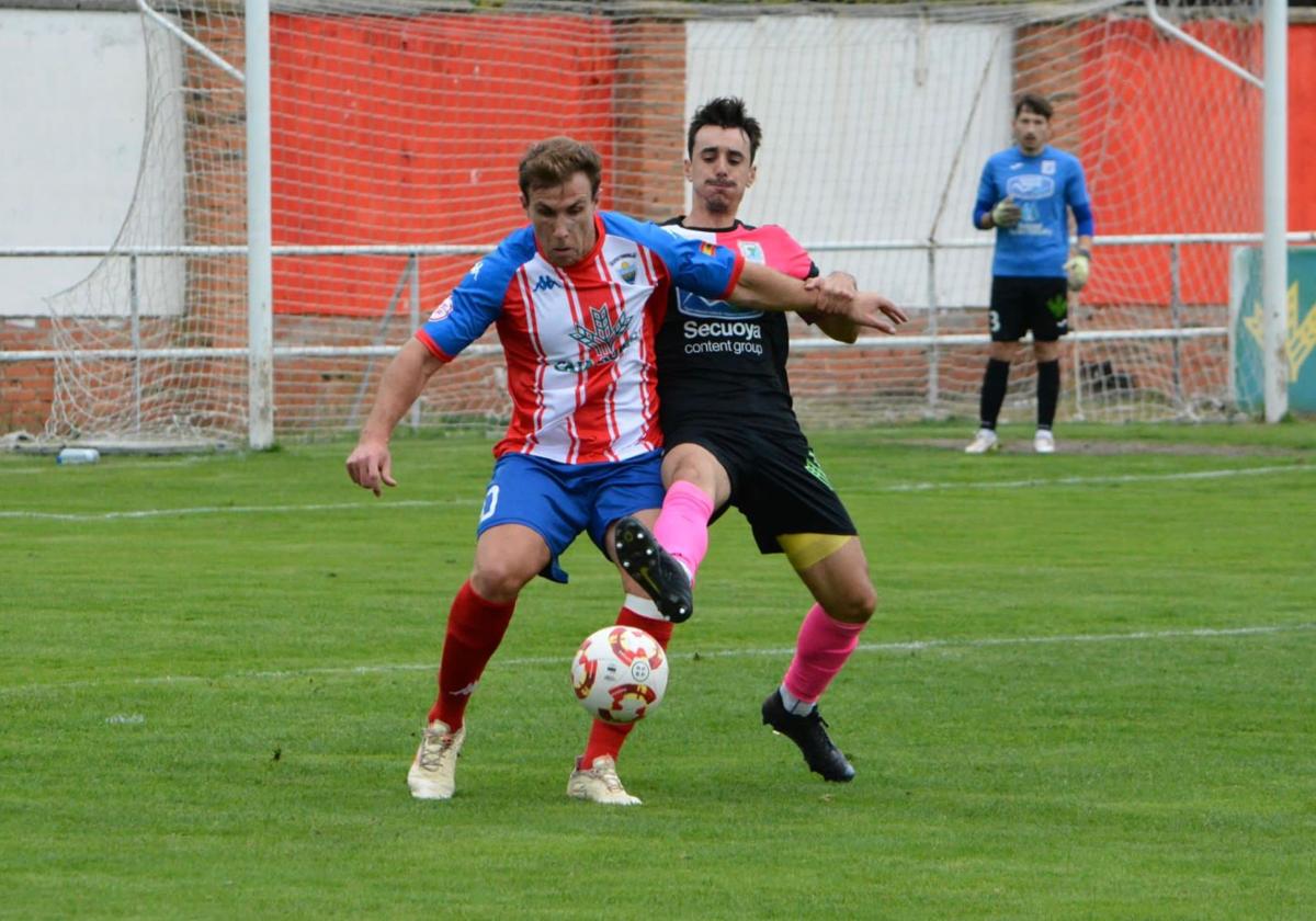 Chatún, que se quedó sin mojar, protege el balón ante un defensa rival.