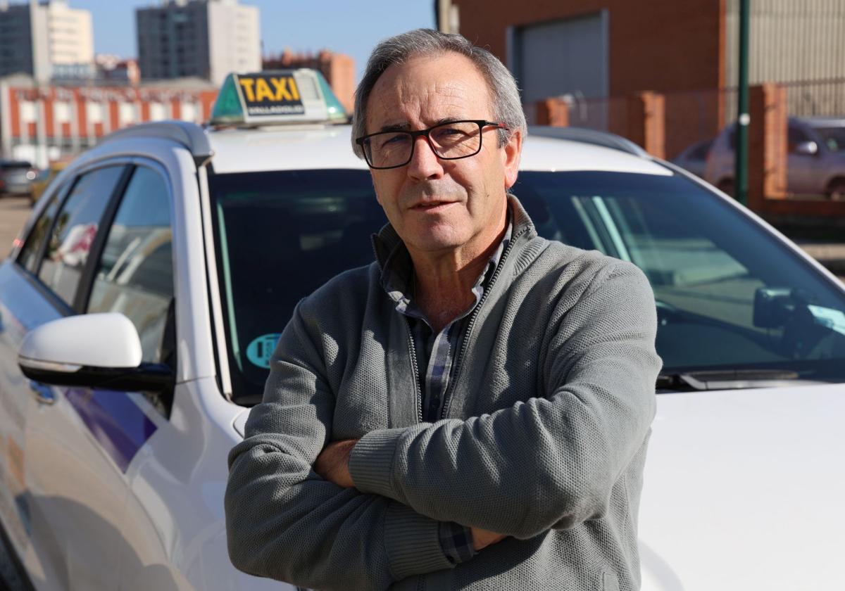 Luis Alberto Herrero, taxista en Valladolid, posa junto a su vehículo.