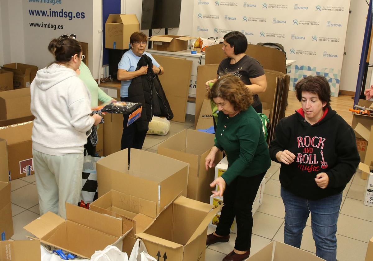 Voluntarias participan en la clasificación y empaquetado de productos para su envío a Valencia.