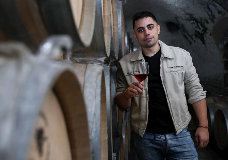 Ricardo Crespo, propietario de EME Bodegas, tomando un clarete apoyado en las barricas de su bodega.