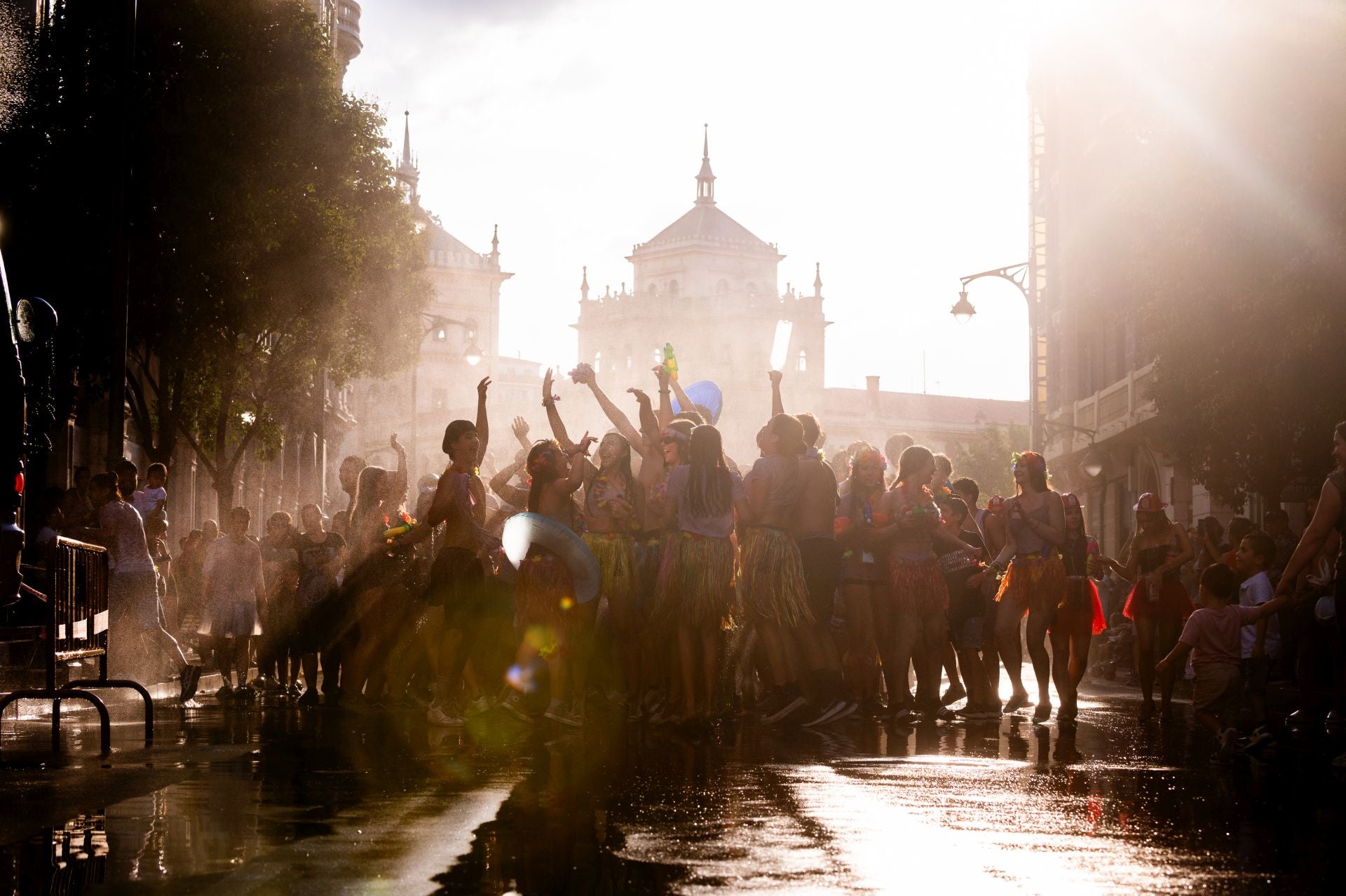 Uno puede meterse de lleno en esta foto sin temor a terminar empapado de calimocho. Aquí el suelo no está pegajoso, pero si uno se queda el tiempo suficiente mirando la imagen, tal vez escuche de fondo los gritos de alegría, la música de los dj. Valladolid descorchó el 30 de agosto unas fiestas de la Virgen de San Lorenzo más madrugadoras de lo habitual. La foto es puro jolgorio, una celebración de vida en Miguel Íscar, con la Academia de Caballería casi difuminada por la luz ahí al final.