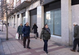 Varios peatones pasan delante del local que ocupaba Supercor en la calle Puente Colgante de Valladolid.