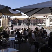 Clientes de dos bares de la Plaza Mayor toman algo en sus terrazas.