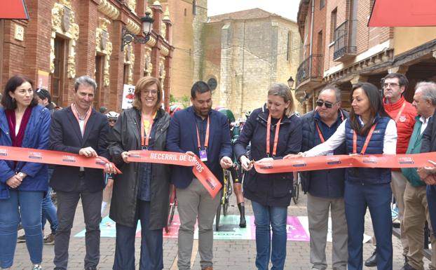 La consejera Isabel Blanco y el alcalde de Becerril, Francisco Pérez, cortan la cinta de salida de la etapa.