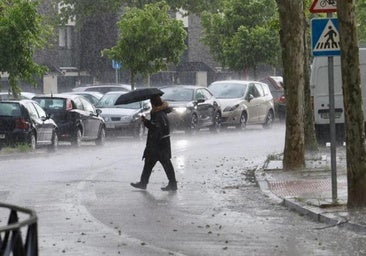 Un vecino con un paraguas durante el aguacero en Valladolid.