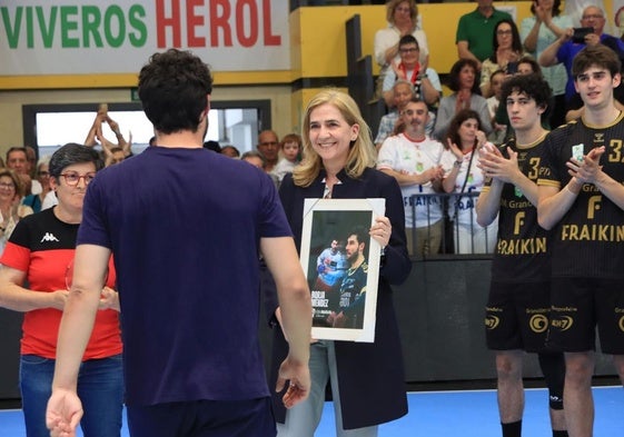 La infanta Cristina entrega la distinción a Borja Méndez, jugador del Balonmano Nava, al final del partido.
