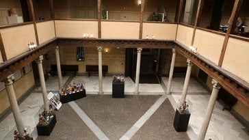 Patio interior de la sede de la Diputación de Segovia en el que se aprecia una exposición temporal.