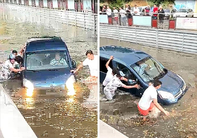 Los vecinos empujan una furgoneta, con el conductor dentro, atrapada bajo el puente de la avenida de la Constitución de Medina del Campo.