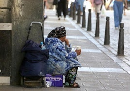 Una mujer practica la mendicidad en una de las calles céntricas de Segovia.