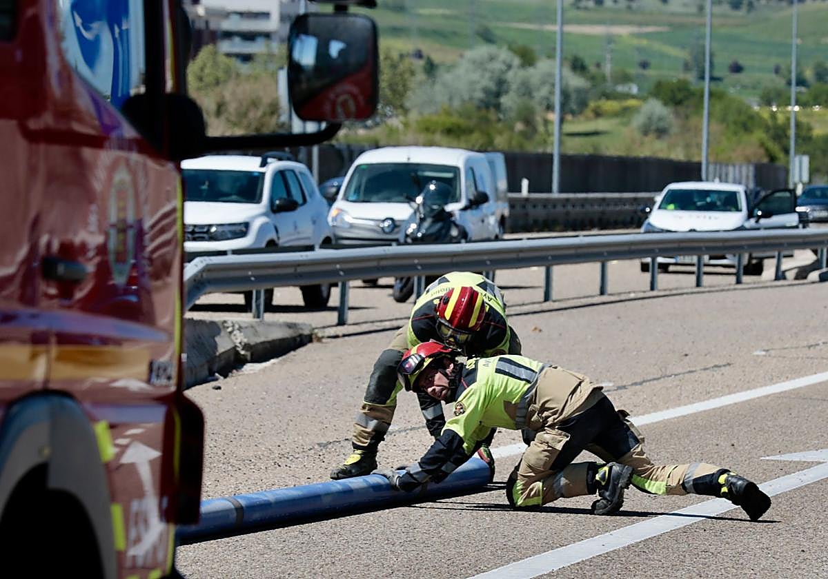 Dos bomberos del Ayuntamiento de Valladolid intervienen en un accidente en la VA-30 en abril de 2024.