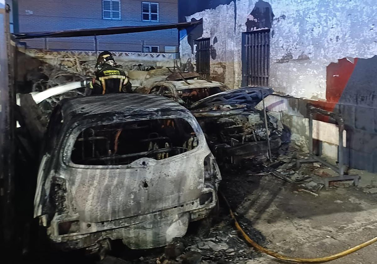 Los bomberos trabajan en la extinción del fuego en el taller de Santovenia.