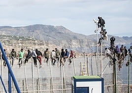 Inmigrantes subidos a la valla de Melilla.
