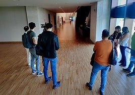 Los periodistas, antes de comenzar el último Pleno de las Cortes, en la zona de acceso al hemiciclo, ante el pasillo vacío.