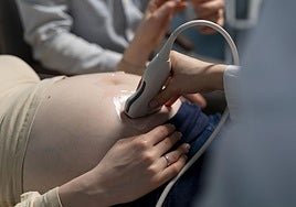 Una matrona realiza una ecografía a una embarazada.