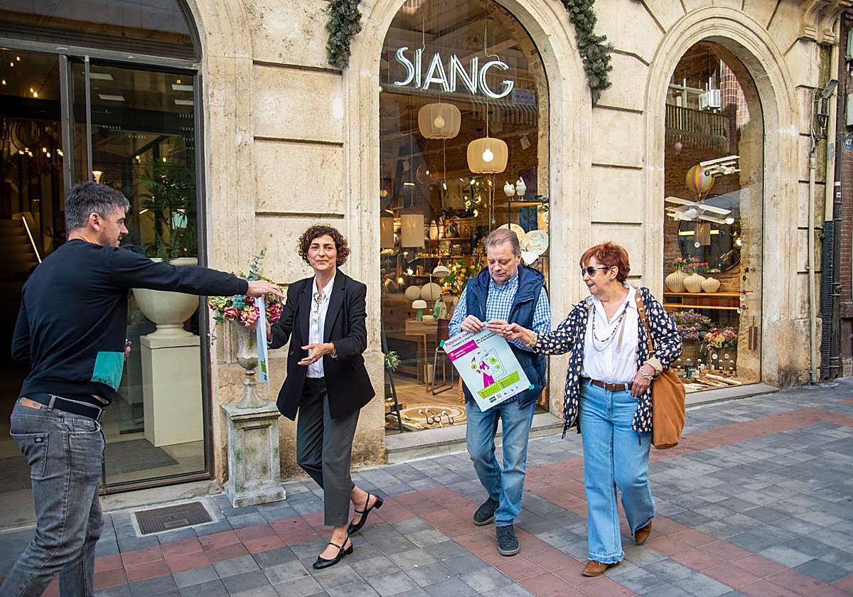 Las concejalas Judith Castro y Mar Rodríguez, con Sergio Domínguez, representante de Palencia Abierta, se disponen a colocar los carteles de la nueva campaña.