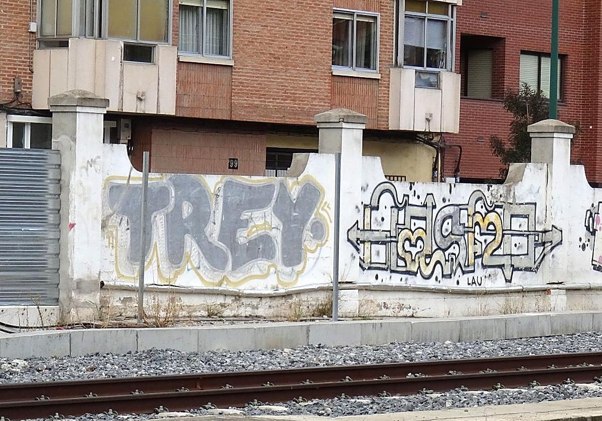 Una pintada descolorida de 'Trey' por el interior del muro ferroviario de la calle Vía.