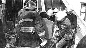 Momento en el que los bomberos rescatan el cadáver del hombre sepultado por el derrumbe en la calle Luna, en 1990.