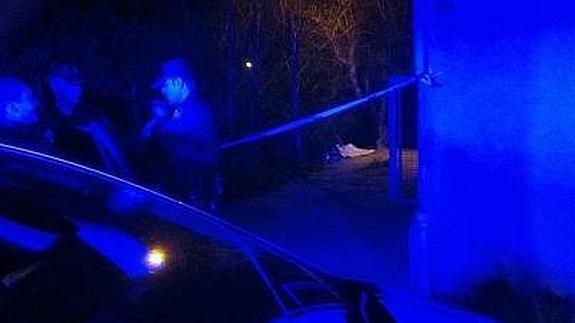 Tres agentes custodian el cuerpo del fallecido.