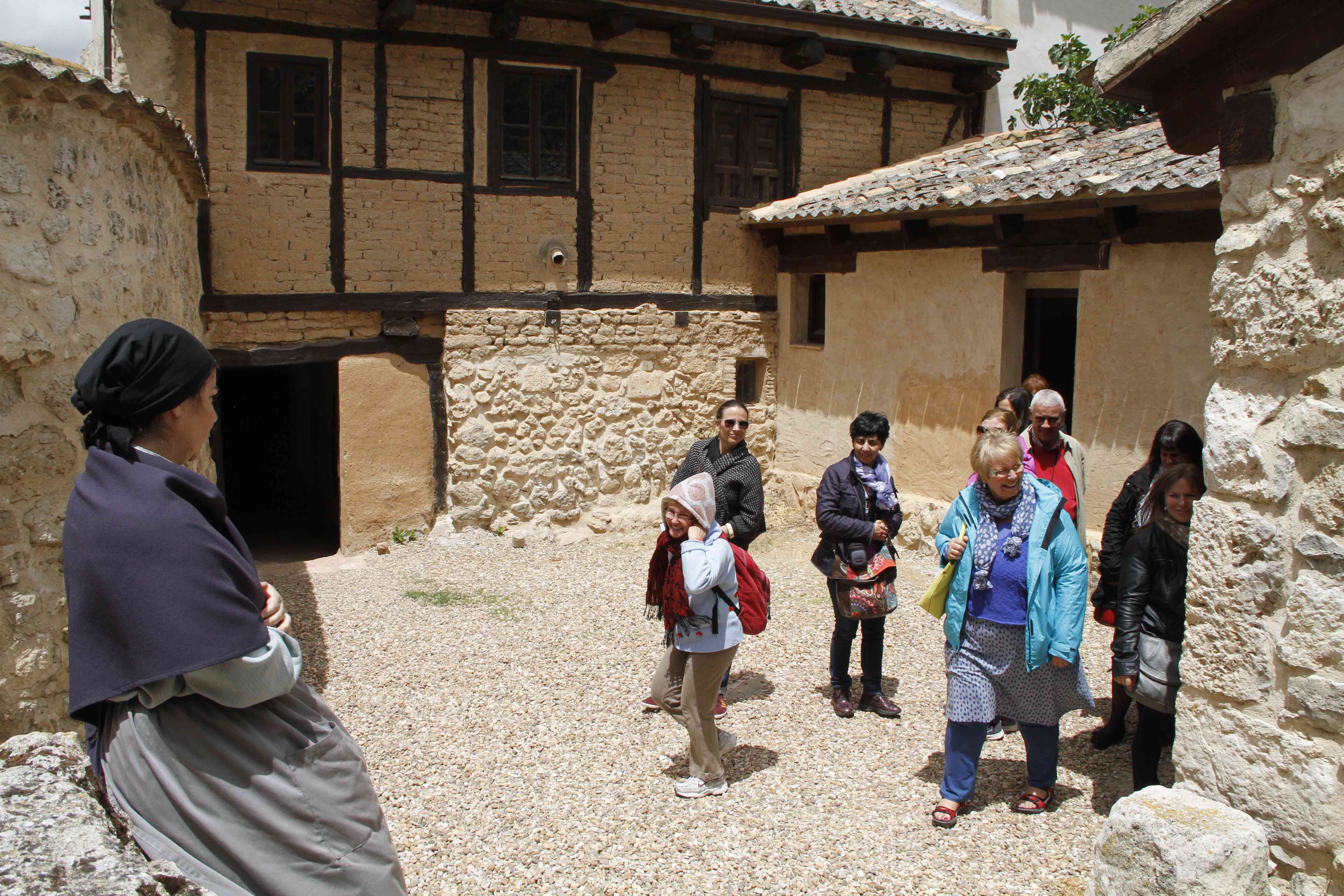 Actriz de Telón de Azúcar con visitantes en el patio de La Casa de la Ribera.