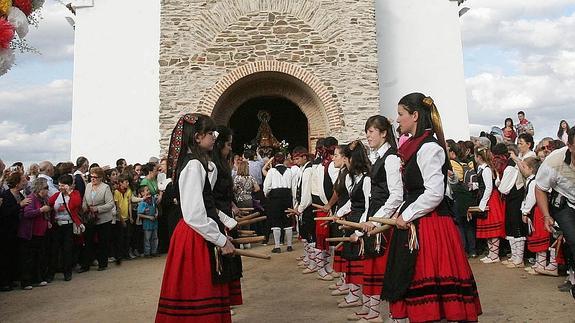 Un grupo de danzas espera la salida de la Virgen del Castillo de la ermita. 