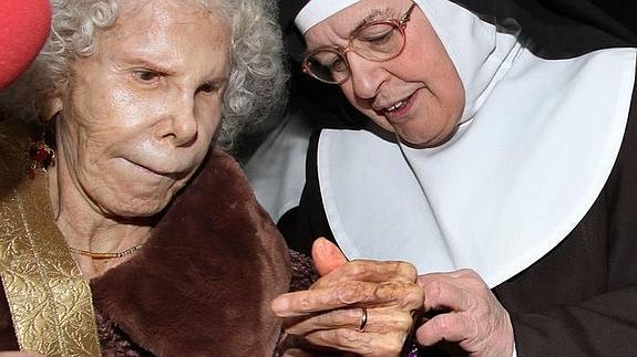 Sor Micaela coloca una pulsera a la duquesa, en su visita a Carrión en diciembre de 2013. 