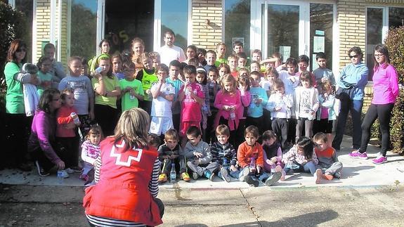 Una monitora de Cruz Roja, junto a los escolares de Astudillo. 