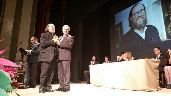 El alcalde de RIoseco, Artemio Domínguez, entrega el reconocimiento a Joaquín Díaz.