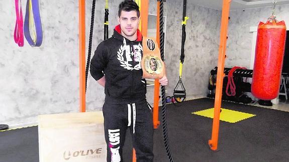 Richard Huerta, posa con el cinturón de campeón del mundo en la modalidad profesional de Kick Boxing en el interior de su estudio.