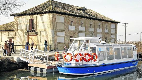 El barco Juan de Homar, atracado en el embarcadero de Villaumbrales, junto a la Casa del Rey, que acoge el museo del Canal.