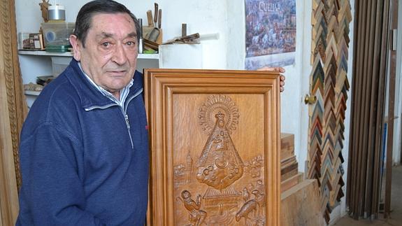 Adolfo Gómez muestra el cuadro de la Virgen del Henar, una de sus obras más queridas. 