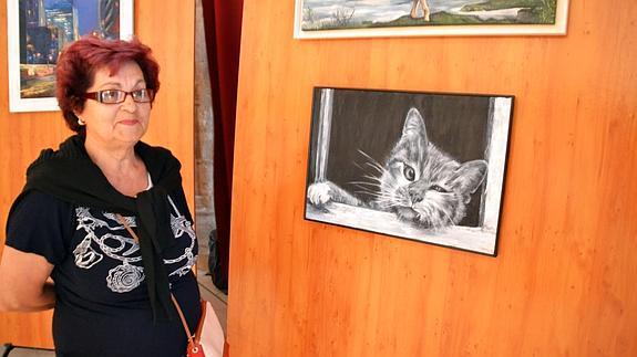 La presidenta de la asociación, Rosa Hernández, ante algunas de las obras.