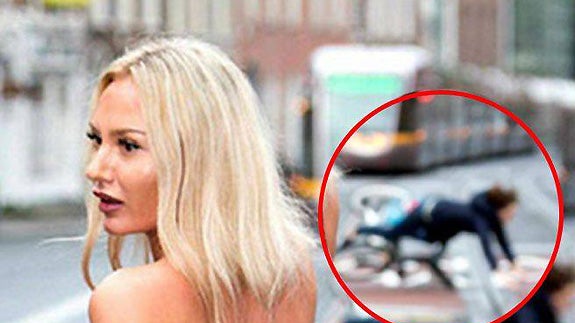 Una modelo en topless provoca la caída de un ciclista